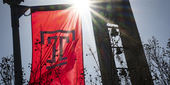 Campus stock of the Bell Tower and a Temple flag.