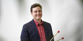 Caleb Breidenbaugh holding a xylophone hammer.