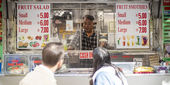 Image of students interviewing a food truck operator.