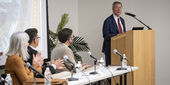Richard Englert at a podium speaking during a Temple Press event.
