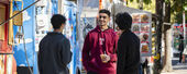 Students standing talking near food trucks on Main Campus