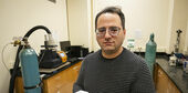 Image of Mehdi Khanzadeh holding a sample of carbonatable concrete.