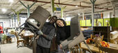 Students hold chairs in a ReStore