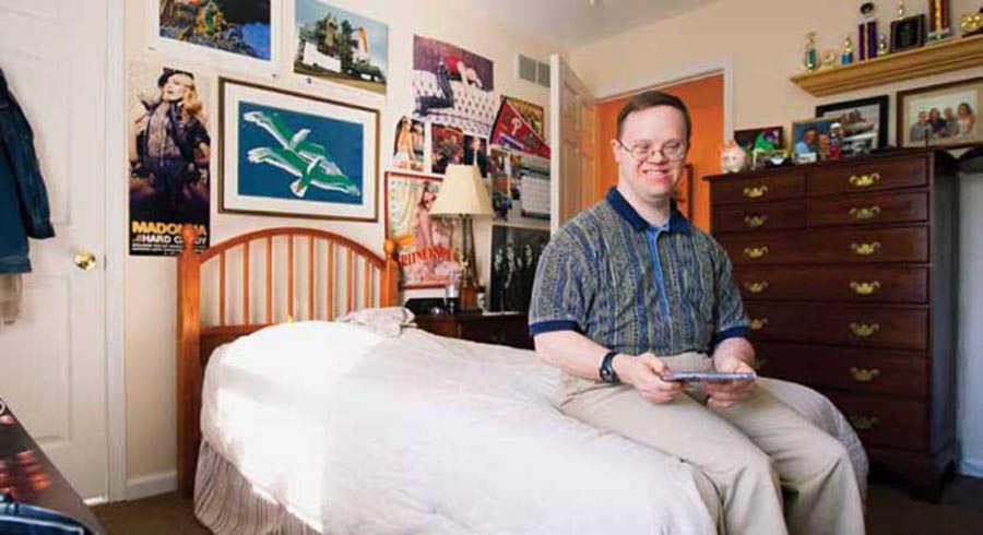 Kevin and his three roommates each have bedrooms that reflect their individual personalities. In the U.S., small-group homes have been replacing large-scale institutions slowly throughout the past century.