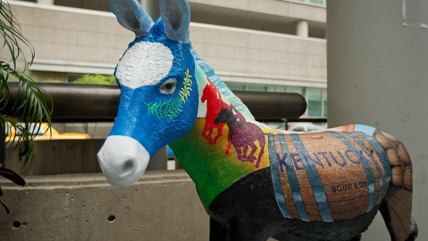 A donkey painted with visual elements representing Kentucky.