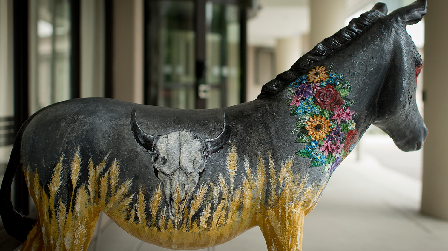 A donkey painted with visual elements representing North Dakota.