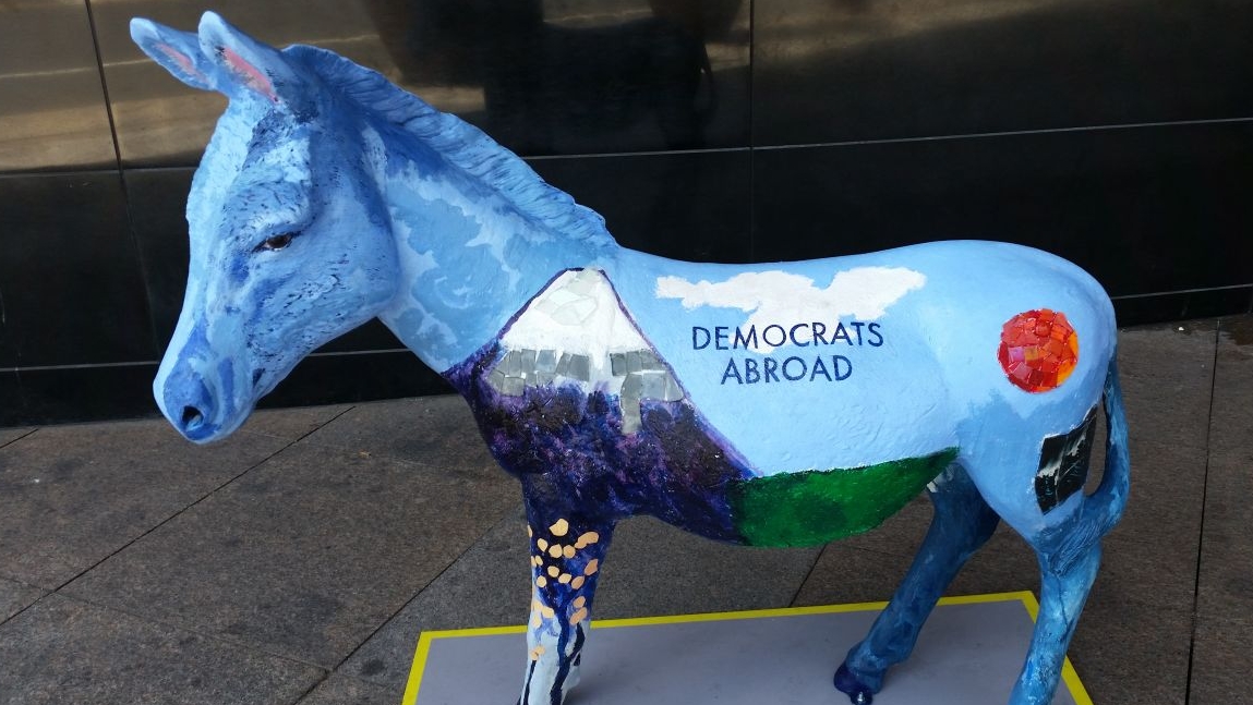 A donkey painted with visual elements representing Democrats living abroad.