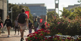 Temple students walking on campus near the Bell Tower