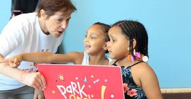 Kathy Hirsh-Pasek interacting with two young students