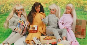 A photo of Barbie dolls having a picnic.