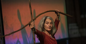 Merián Soto holding branches as part of her choreography 