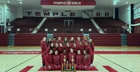  Image of Temple’s dance team wearing cherry and white posing in front of trophies.  