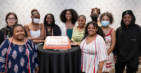 Temple Education Scholars with a cake 