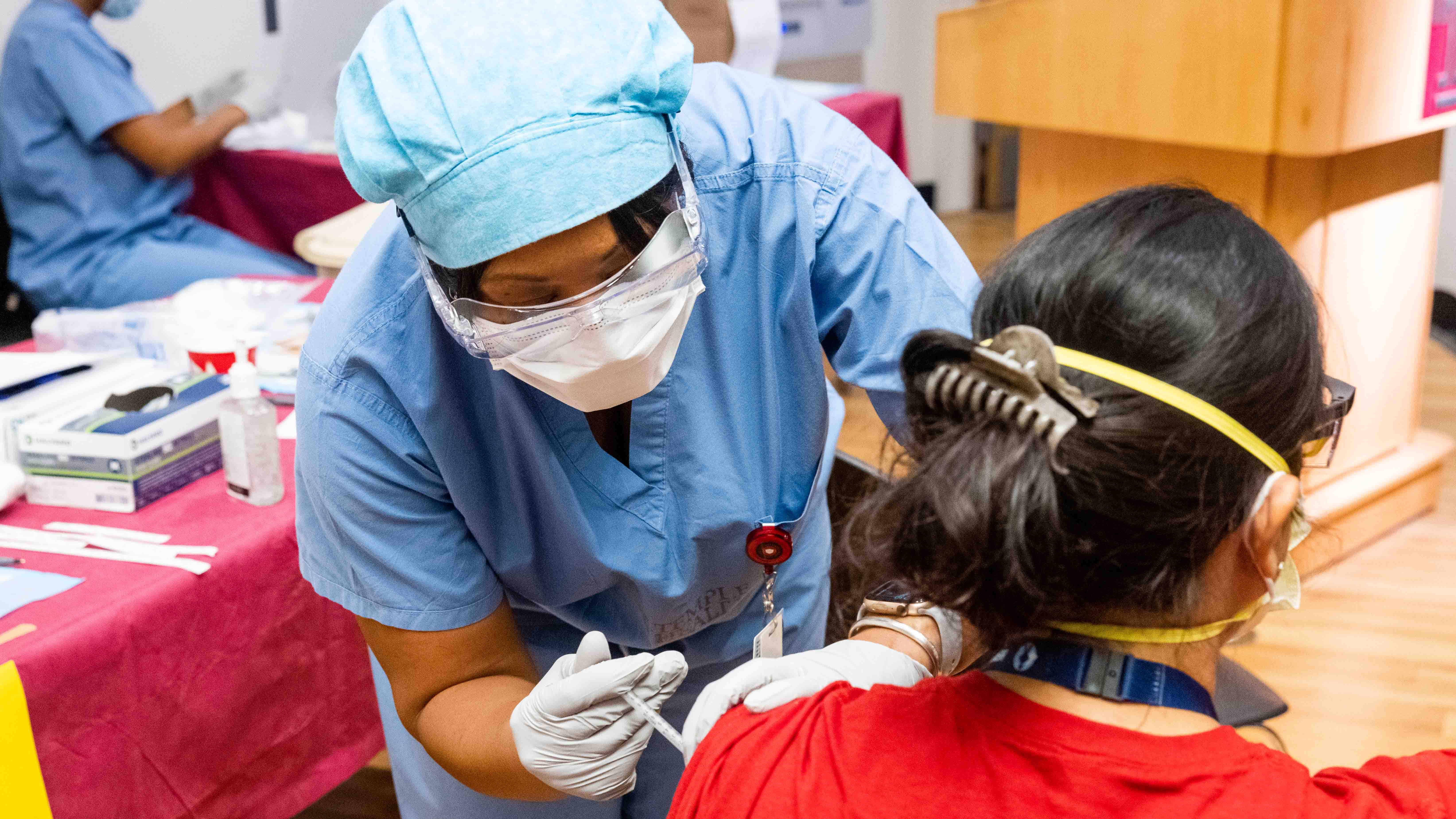 front-line worker receiving a vaccine injection