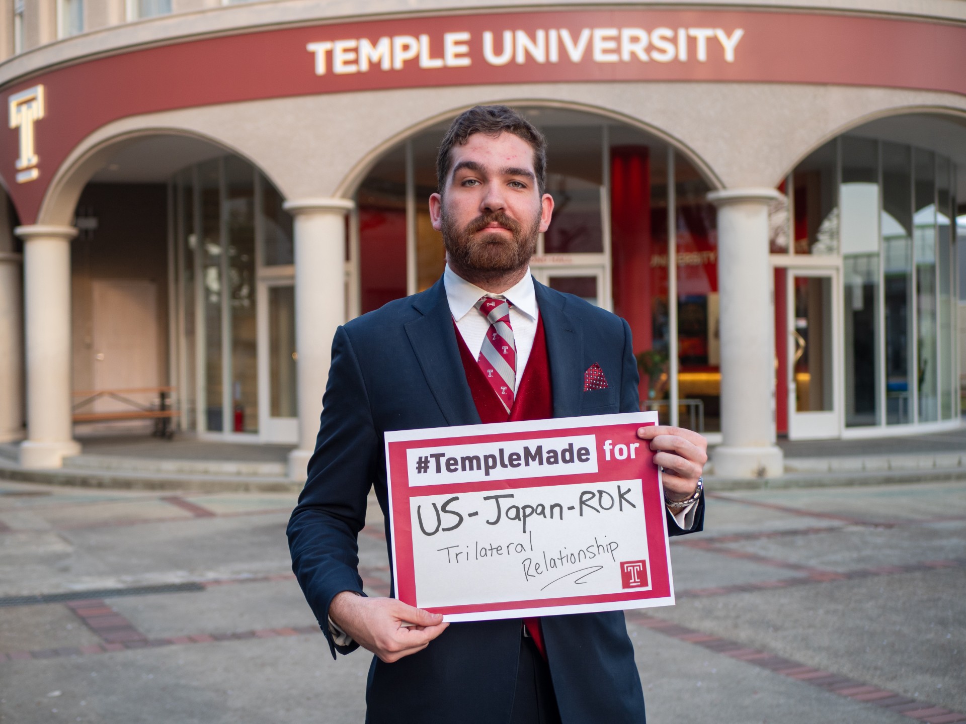 Soren holds sign saying “#TempleMade for US-Japan-ROK Trilateral Relationship”
