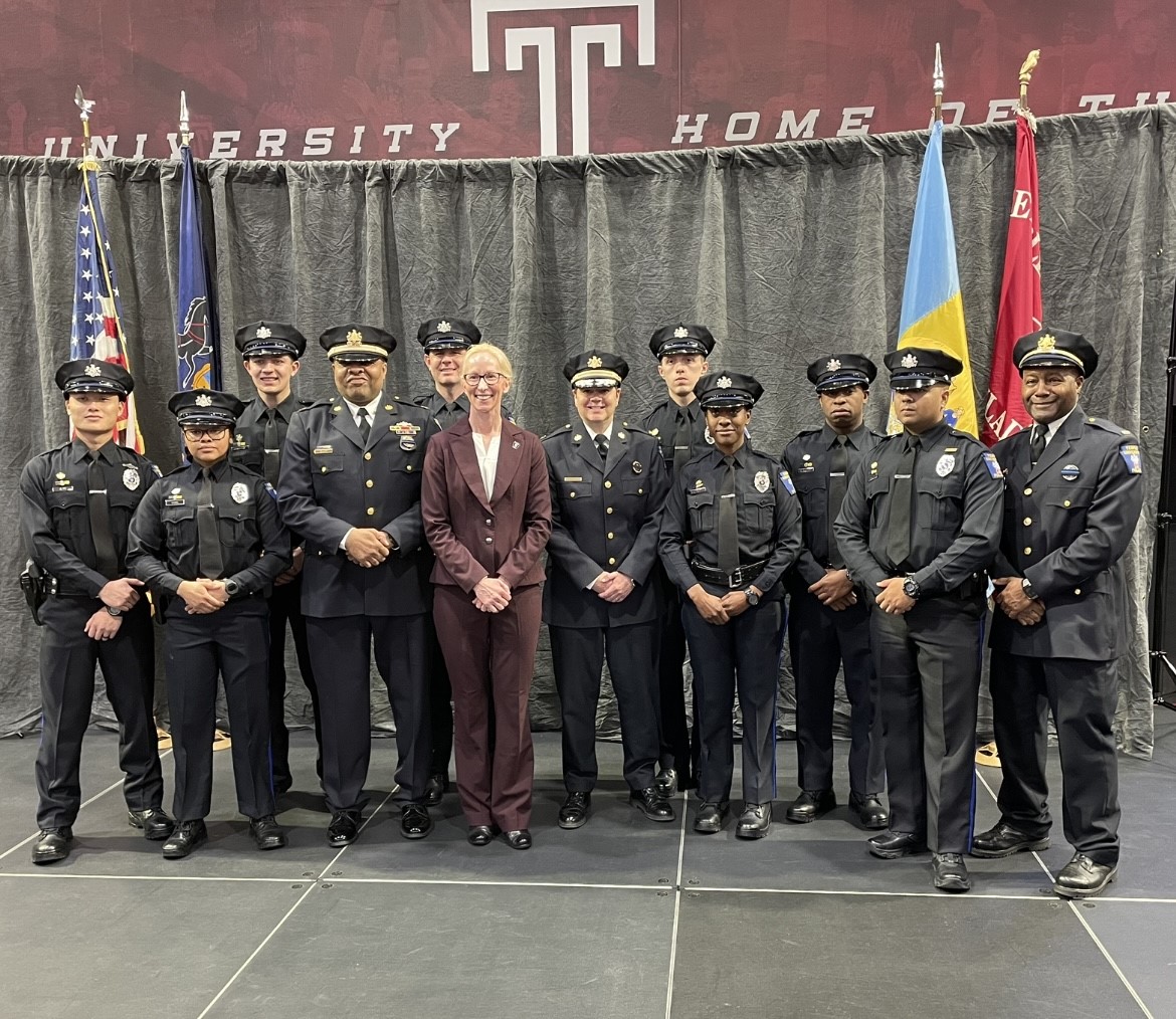 Jennifer Griffin, Temple’s vice president for public safety, poses with the new officers after their graduation ceremony.