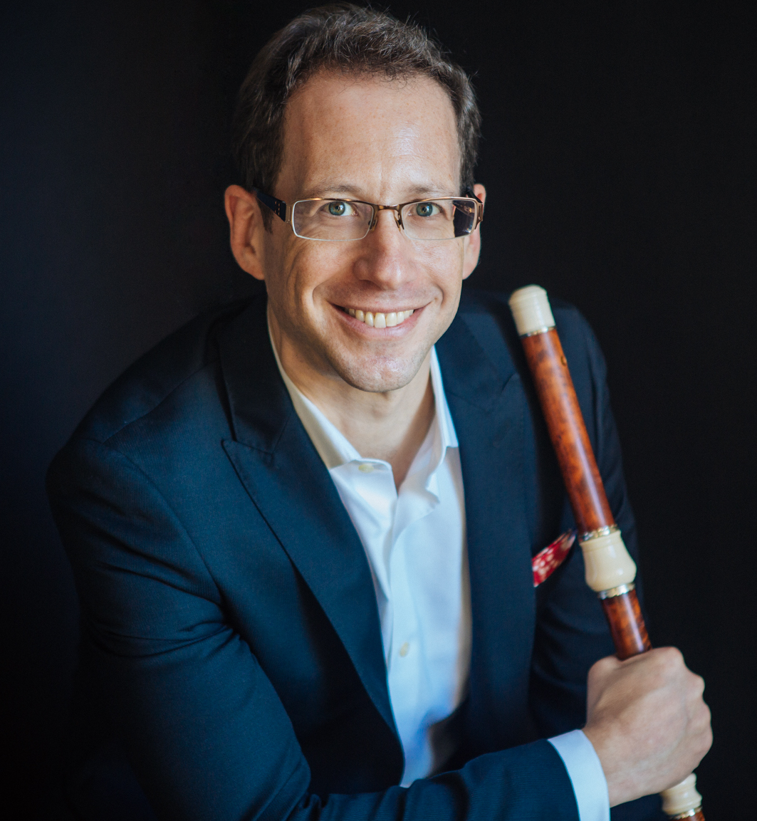 Smiling man holding an early flute